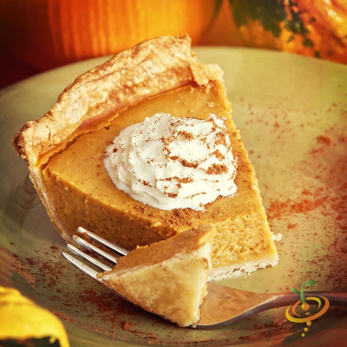 Slice of pumpkin pie with whipped cream and cinnamon sprinkled on plate, made from Small Sugar pumpkin seeds