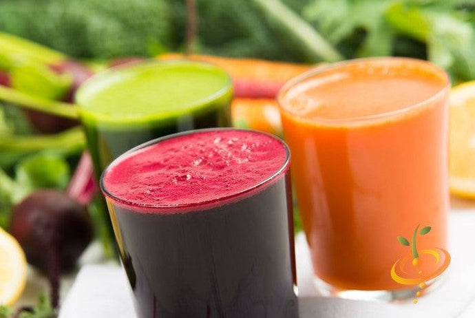 Three glasses of fresh vegetable juice including vibrant red Boltardy beet juice in the foreground